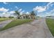 Sprawling home showcasing curb appeal with a circular driveway and meticulously maintained lawn and landscaping at 7301 Loghouse Rd, Plant City, FL 33565