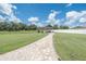 Backyard gazebo providing a relaxing space with views of the picturesque pond and manicured lawn at 7301 Loghouse Rd, Plant City, FL 33565