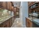 Hallway with bar area features wood cabinets, granite countertops, and stainless steel appliances at 7301 Loghouse Rd, Plant City, FL 33565