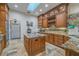 Modern kitchen with a skylight, granite countertops, and custom wood cabinets at 7301 Loghouse Rd, Plant City, FL 33565