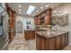 Gourmet kitchen featuring custom cabinetry, granite countertops, and stainless steel appliances at 7301 Loghouse Rd, Plant City, FL 33565