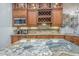 Modern kitchen featuring a custom wine rack, stainless steel appliances and granite countertops at 7301 Loghouse Rd, Plant City, FL 33565