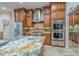 Bright kitchen with professional-grade stainless steel appliances and granite countertops at 7301 Loghouse Rd, Plant City, FL 33565