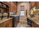 The laundry room has stunning wood cabinets, granite countertops, and stainless steel appliances at 7301 Loghouse Rd, Plant City, FL 33565