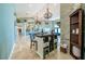Wide open living room featuring a bar, pool table, and chandeliers at 7301 Loghouse Rd, Plant City, FL 33565