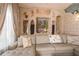 Living room with a comfortable gray sectional, stone accent wall, and niche shelving at 7301 Loghouse Rd, Plant City, FL 33565