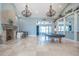 Expansive living room featuring high ceilings, natural light, and stone fireplace at 7301 Loghouse Rd, Plant City, FL 33565
