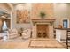 Spacious living room with fireplace, travertine tile flooring, and comfortable seating at 7301 Loghouse Rd, Plant City, FL 33565