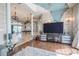 Spacious living room with an open floor plan, chandeliers, stone accents, and travertine and wood floors at 7301 Loghouse Rd, Plant City, FL 33565