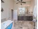 The main bathroom has a soaking tub, a vanity with double sinks, and a large mirror at 7301 Loghouse Rd, Plant City, FL 33565
