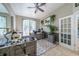 Office space with large windows, a ceiling fan, and a combination of neutral wall colors at 7301 Loghouse Rd, Plant City, FL 33565
