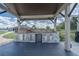 Outdoor grilling area with stainless steel grill and stone surround, ideal for al fresco dining and entertaining at 7301 Loghouse Rd, Plant City, FL 33565