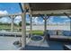 Covered outdoor living space with comfortable seating, a fire pit, and scenic views of the lush backyard at 7301 Loghouse Rd, Plant City, FL 33565