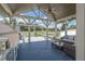 Spacious outdoor living area with comfortable seating, built-in grill, and scenic views of the serene pond at 7301 Loghouse Rd, Plant City, FL 33565
