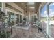 This screened in lanai features a dining area, a lounge area and views of the beautiful backyard at 7301 Loghouse Rd, Plant City, FL 33565