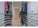 This walk-in closet has built in storage for shoes, clothes, and accessories at 7301 Loghouse Rd, Plant City, FL 33565