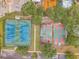 Aerial view of a sports complex with tennis and basketball courts amid lush greenery at 734 Flamingo Dr, Apollo Beach, FL 33572