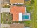 Aerial view of a property with a vibrant red tile roof, a private backyard pool and well-maintained landscaping at 734 Flamingo Dr, Apollo Beach, FL 33572