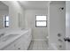 This bright bathroom features double sinks, a shower and tub combo at 734 Flamingo Dr, Apollo Beach, FL 33572