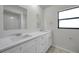 The bright bathroom features double sinks and white cabinets at 734 Flamingo Dr, Apollo Beach, FL 33572