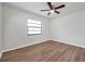Bright bedroom features neutral walls, wood-look flooring, and a ceiling fan at 734 Flamingo Dr, Apollo Beach, FL 33572