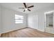 Bright bedroom features neutral walls, wood-look flooring, and closet at 734 Flamingo Dr, Apollo Beach, FL 33572