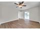 Sun-filled bedroom with wood-look floors and access to the screened-in pool area at 734 Flamingo Dr, Apollo Beach, FL 33572