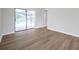 Bedroom with new floors and large glass sliding doors that offer a view of the screened-in pool at 734 Flamingo Dr, Apollo Beach, FL 33572
