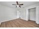 This bright bedroom features neutral walls, wood-look flooring and walk-in closet at 734 Flamingo Dr, Apollo Beach, FL 33572