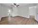 Bright bedroom featuring wood-look floors, a ceiling fan, and an ensuite bathroom at 734 Flamingo Dr, Apollo Beach, FL 33572