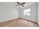 Bright bedroom features neutral walls, wood-look flooring and a ceiling fan at 734 Flamingo Dr, Apollo Beach, FL 33572