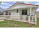 Rear exterior view of a white home with an orange tile roof and a small covered patio area at 734 Flamingo Dr, Apollo Beach, FL 33572