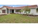 Beautiful single-story home with a well-kept lawn and blooming tree, adding charm to the property at 734 Flamingo Dr, Apollo Beach, FL 33572