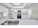 Modern kitchen featuring white cabinets, quartz countertops and stainless steel appliances at 734 Flamingo Dr, Apollo Beach, FL 33572