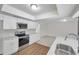 Modern kitchen featuring white cabinets, quartz countertops and stainless steel appliances at 734 Flamingo Dr, Apollo Beach, FL 33572