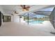 Inviting screened-in lanai with ceiling fans, a sparkling pool, and serene outdoor views at 734 Flamingo Dr, Apollo Beach, FL 33572