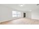 Spacious living room with light wood flooring, neutral walls, and a large window for ample natural light at 734 Flamingo Dr, Apollo Beach, FL 33572