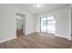Bright room with new flooring, neutral walls, and sliding glass doors opening to the pool at 734 Flamingo Dr, Apollo Beach, FL 33572