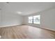 Well-lit living room with plank flooring, a large window, and neutral paint colors at 734 Flamingo Dr, Apollo Beach, FL 33572