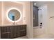 Modern bathroom featuring a vanity, backlit mirror, and a shower/tub combination with grey tiling at 777 3Rd N Ave # 1607, St Petersburg, FL 33701