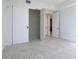 Bright room features white trim, tile floors and an open closet, as well as an open doorway to more rooms at 777 3Rd N Ave # 1607, St Petersburg, FL 33701