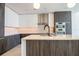 Modern kitchen featuring stainless steel appliances, a central island, and stylish dark wood cabinets at 777 3Rd N Ave # 1607, St Petersburg, FL 33701