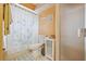Bathroom with floral shower curtain and cabinet at 7810 Flintlock Dr, Port Richey, FL 34668