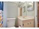 Well-lit bathroom featuring a cream-colored single sink vanity with ample cabinet storage space and neutral colored walls at 7810 Flintlock Dr, Port Richey, FL 34668