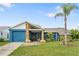 Charming single-story home features a blue exterior with stone accents and a well-manicured lawn at 7810 Flintlock Dr, Port Richey, FL 34668