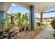View from the front porch showing the charming landscape, plants, and inviting front door at 7810 Flintlock Dr, Port Richey, FL 34668