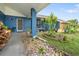 Close-up of the inviting front porch with colorful landscaping and attractive entryway at 7810 Flintlock Dr, Port Richey, FL 34668
