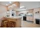 Functional kitchen with breakfast bar, ample counter space and white appliances at 7810 Flintlock Dr, Port Richey, FL 34668