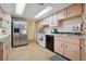 Bright kitchen featuring stainless steel refrigerator and white appliances at 7810 Flintlock Dr, Port Richey, FL 34668