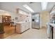 Open concept kitchen with stainless steel appliances and breakfast bar at 7810 Flintlock Dr, Port Richey, FL 34668
